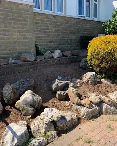 After: the rockery cleared back to stones and soil